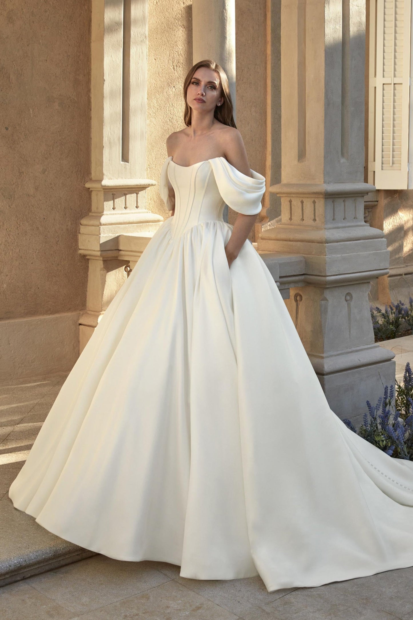 Front view of the Anabela Mikado ball gown wedding dress featuring a drop waist, exposed boning, and off-the-shoulder straps.