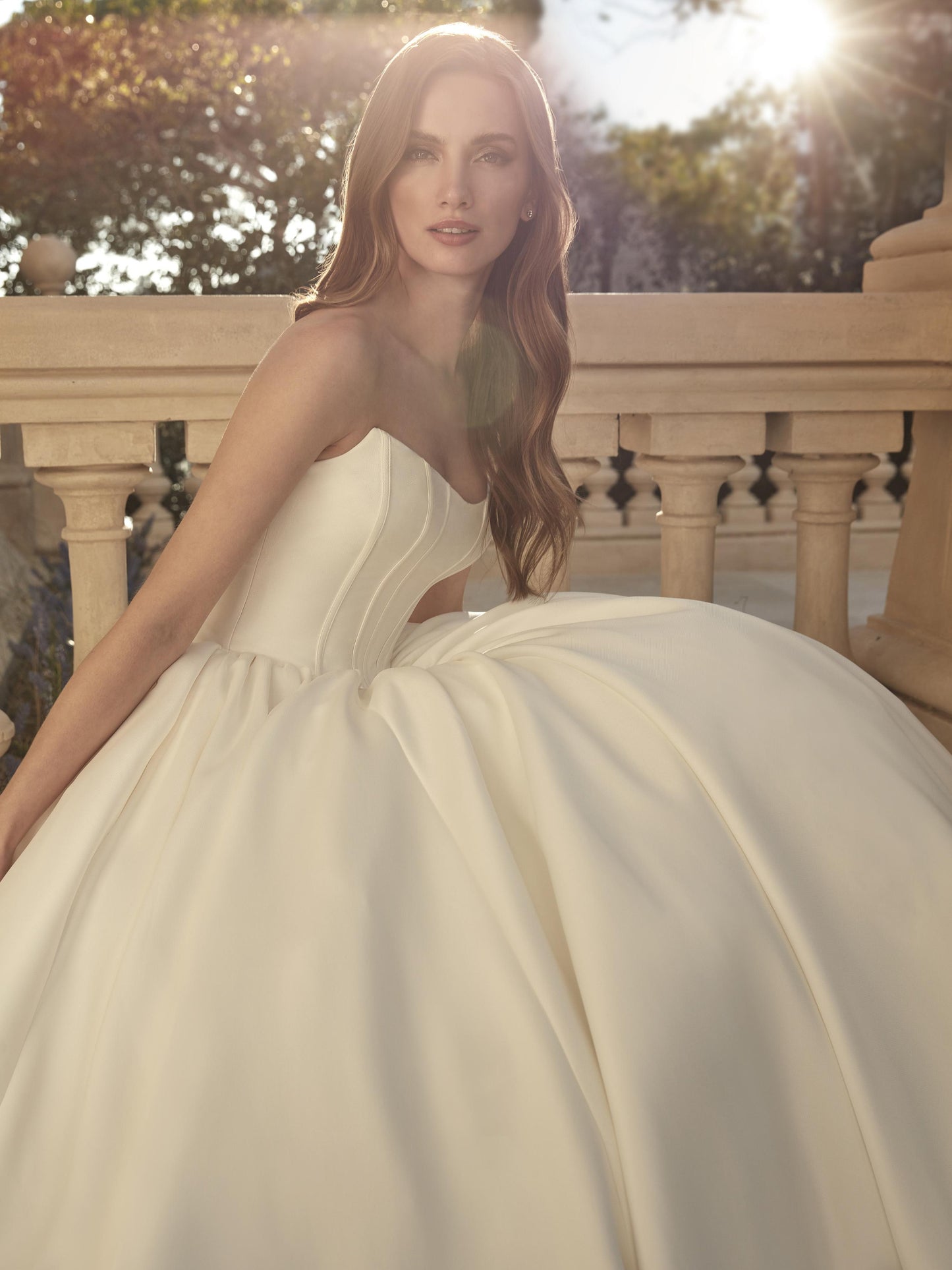 Close-up front view of the Anabela Mikado ball gown wedding dress featuring a straight strapless neckline, exposed boning, and voluminous skirt.