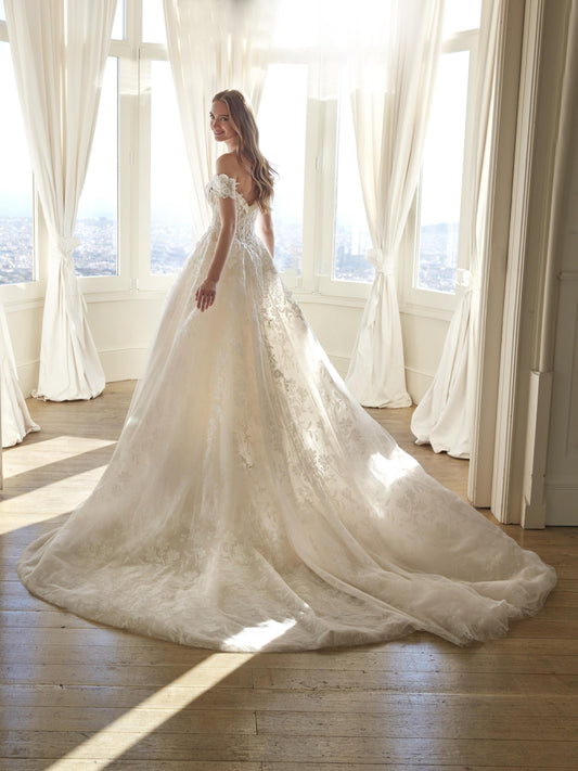 Back view of the Juddy princess wedding dress featuring off-the-shoulder floral straps and a glitter tulle skirt with cathedral train.