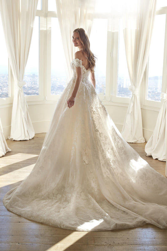 Back view of the Juddy princess wedding dress featuring off-the-shoulder floral straps and a glitter tulle skirt with cathedral train.