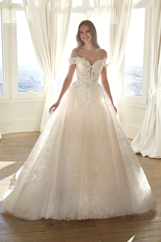 Front view of the Juddy sparkly princess wedding dress featuring off-the-shoulder floral straps, a subtle drop waist, and a glitter tulle skirt.