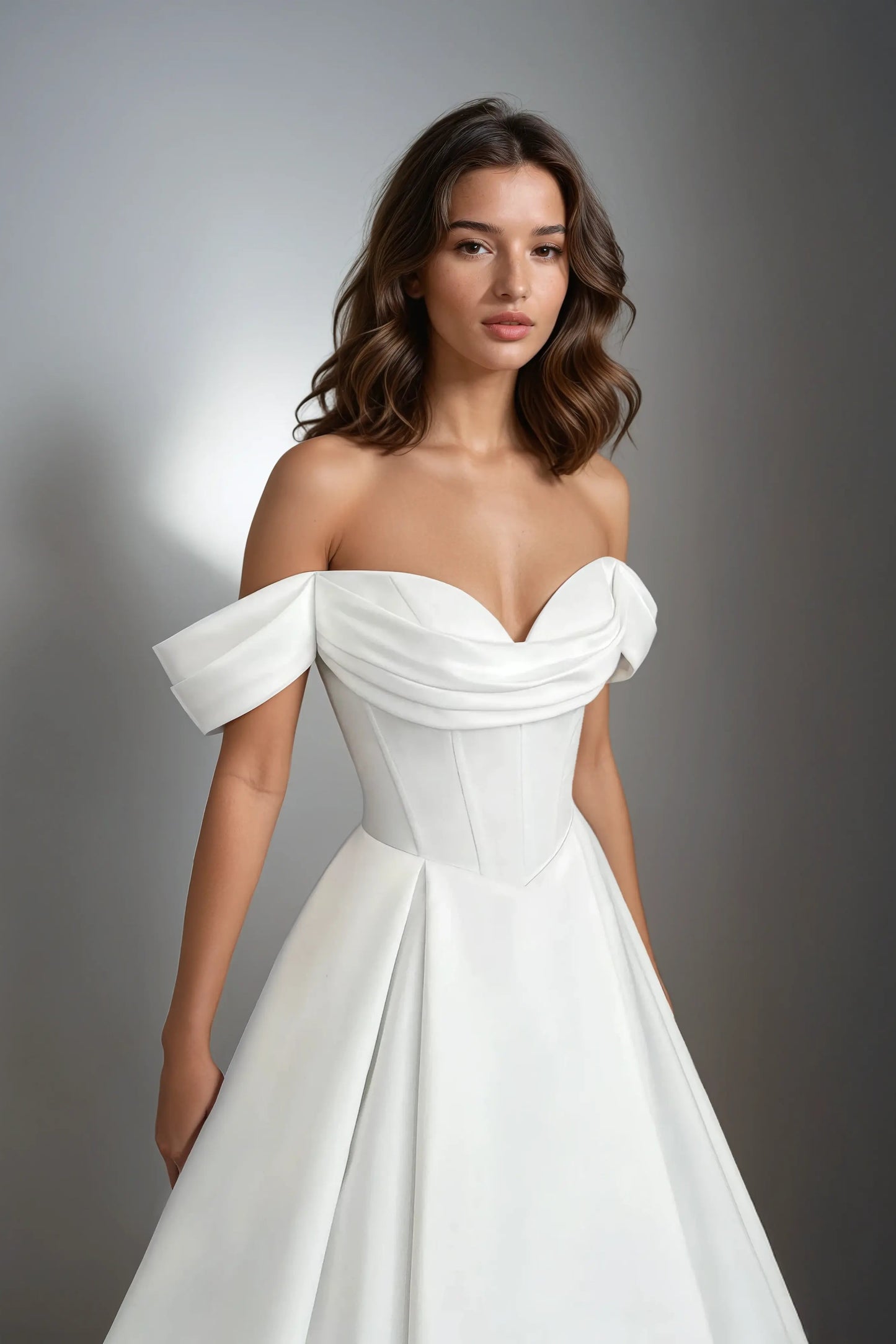 Front view of the Solana satin A-line wedding dress featuring a sweetheart neckline, off-the-shoulder straps, drop waist, and structured bodice.