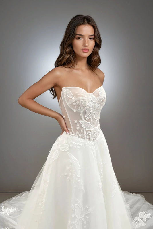 Front view of the Willow strapless A-line wedding dress featuring a drop waist, floral lace, sheer structured bodice, and soft tulle skirt.