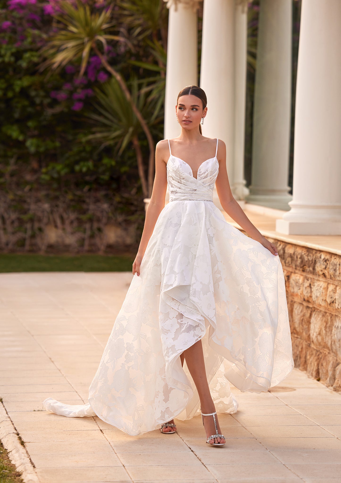 Front view of the Arran A-line wedding dress featuring a high-low skirt, thin spaghetti straps, sweetheart neckline, and a ruched bodice.