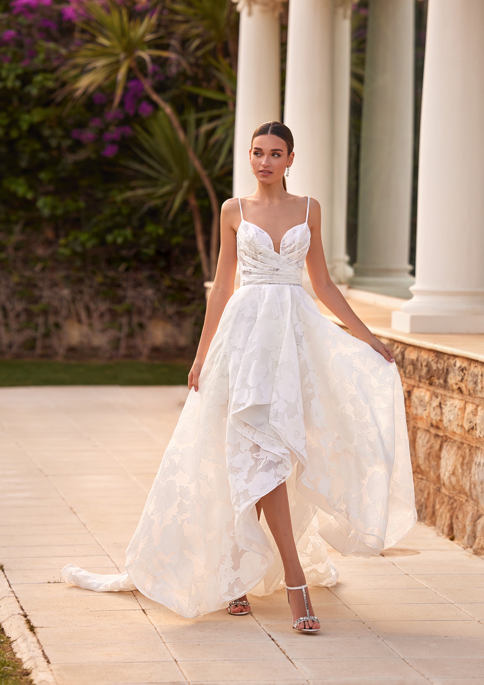 Front view of the Arran A-line wedding dress featuring a high-low skirt, thin spaghetti straps, sweetheart neckline, and a ruched bodice.
