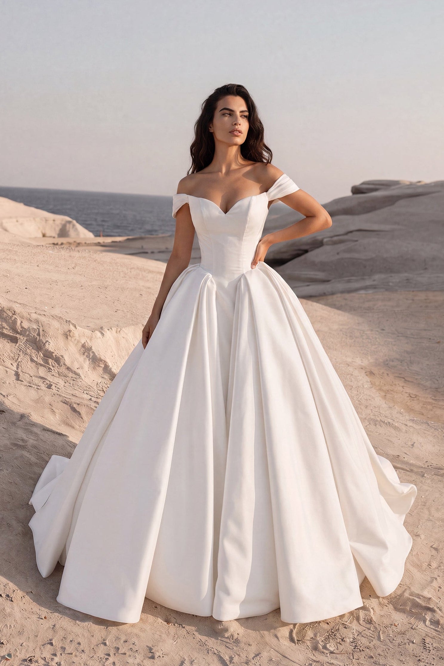 Front view of the Eliana wedding dress featuring an off-the-shoulder sweetheart neckline, structured basque waist, and voluminous Mikado ball gown skirt.