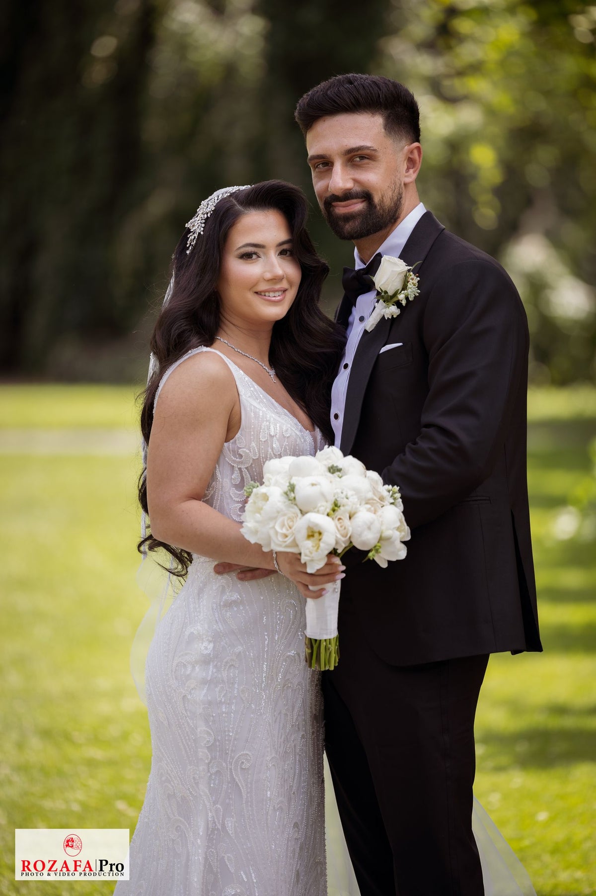 Bride Rochelle in a beaded mermaid wedding dress by Krismil Bridal, posing with her husband Murat at Untermyer Gardens Conservancy.