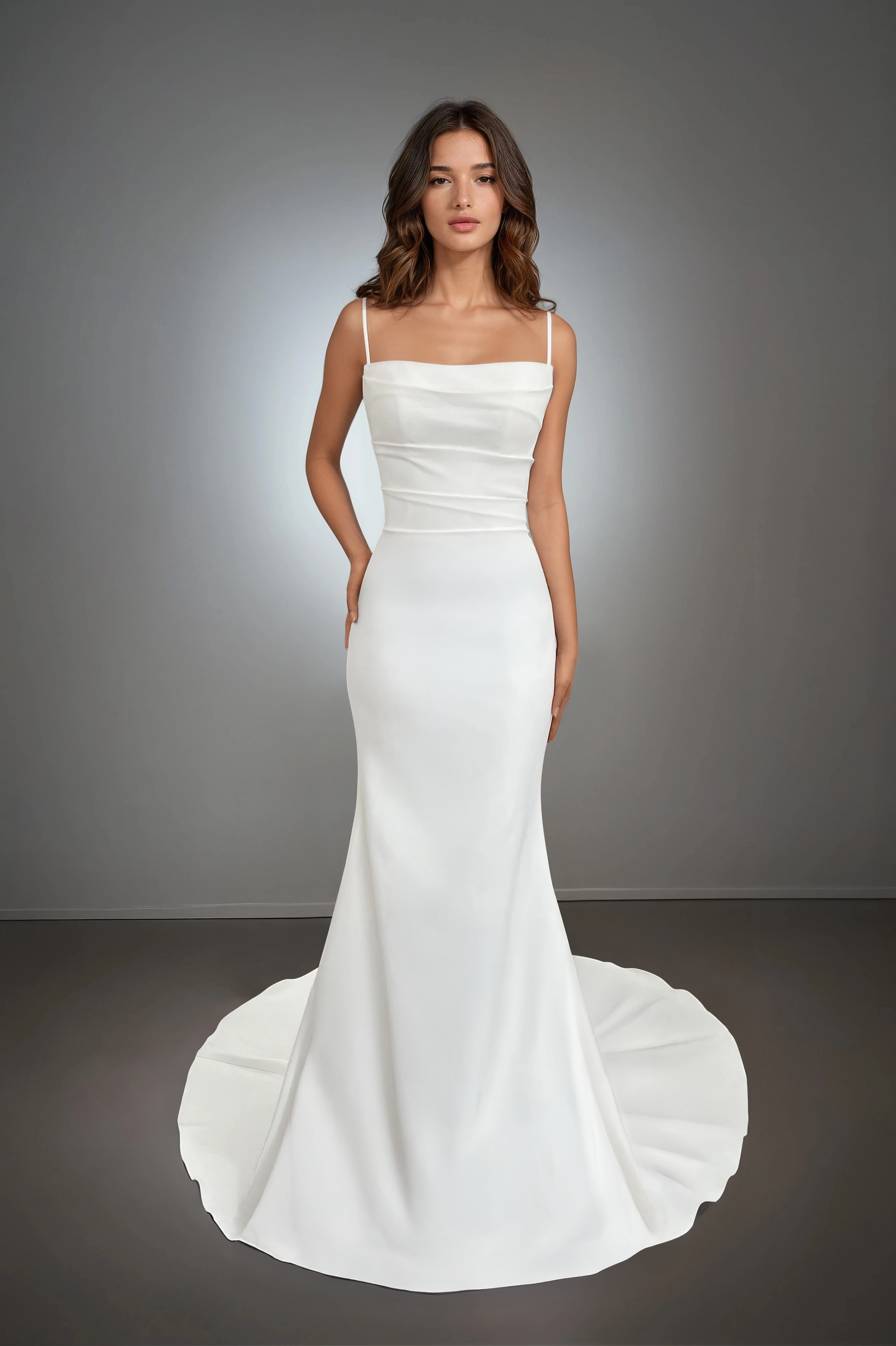 Front view of the Sydney wedding dress featuring thin spaghetti straps, a softly draped bodice, and a mermaid silhouette with a clean train.