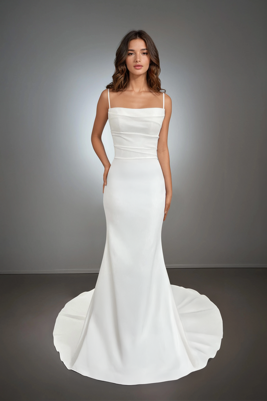 Front view of the Sydney wedding dress featuring thin spaghetti straps, a softly draped bodice, and a mermaid silhouette with a clean train.