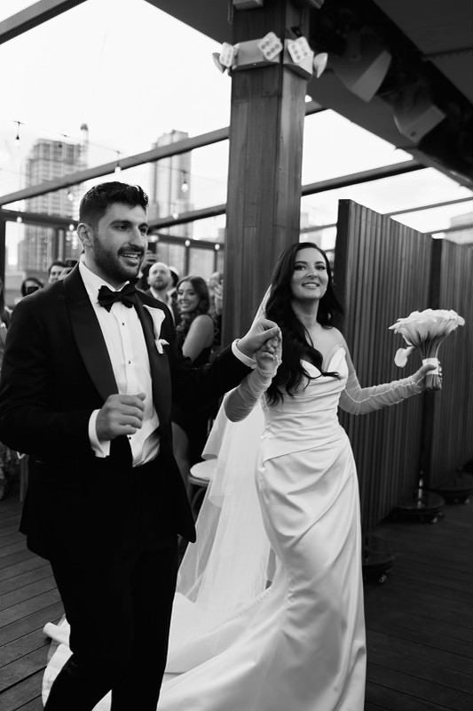 Bride Valerie in a satin mermaid wedding dress by Krismil Bridal, dancing with her husband Pirouz during their wedding at Box House Hotel in Brooklyn.