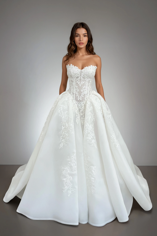 Front view of the Victoria ball gown wedding dress featuring a strapless lace bodice, basque waist, and voluminous organza skirt with floral appliqués.