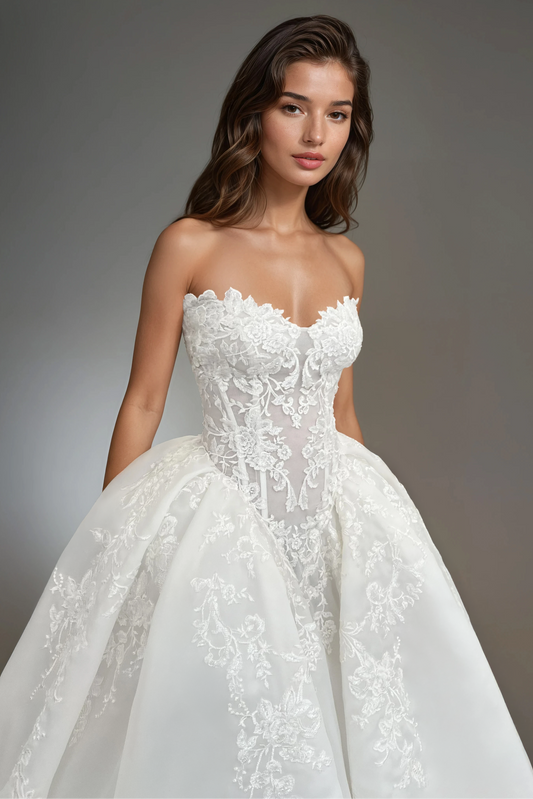 Close-up front view of the Victoria wedding dress featuring a strapless sweetheart neckline, intricate lace bodice, drop waist, and voluminous organza skirt.