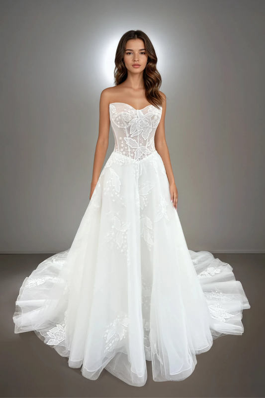 Full-length front view of the Willow A-line wedding dress featuring a drop waist, floral lace, strapless neckline, and sheer structured bodice.