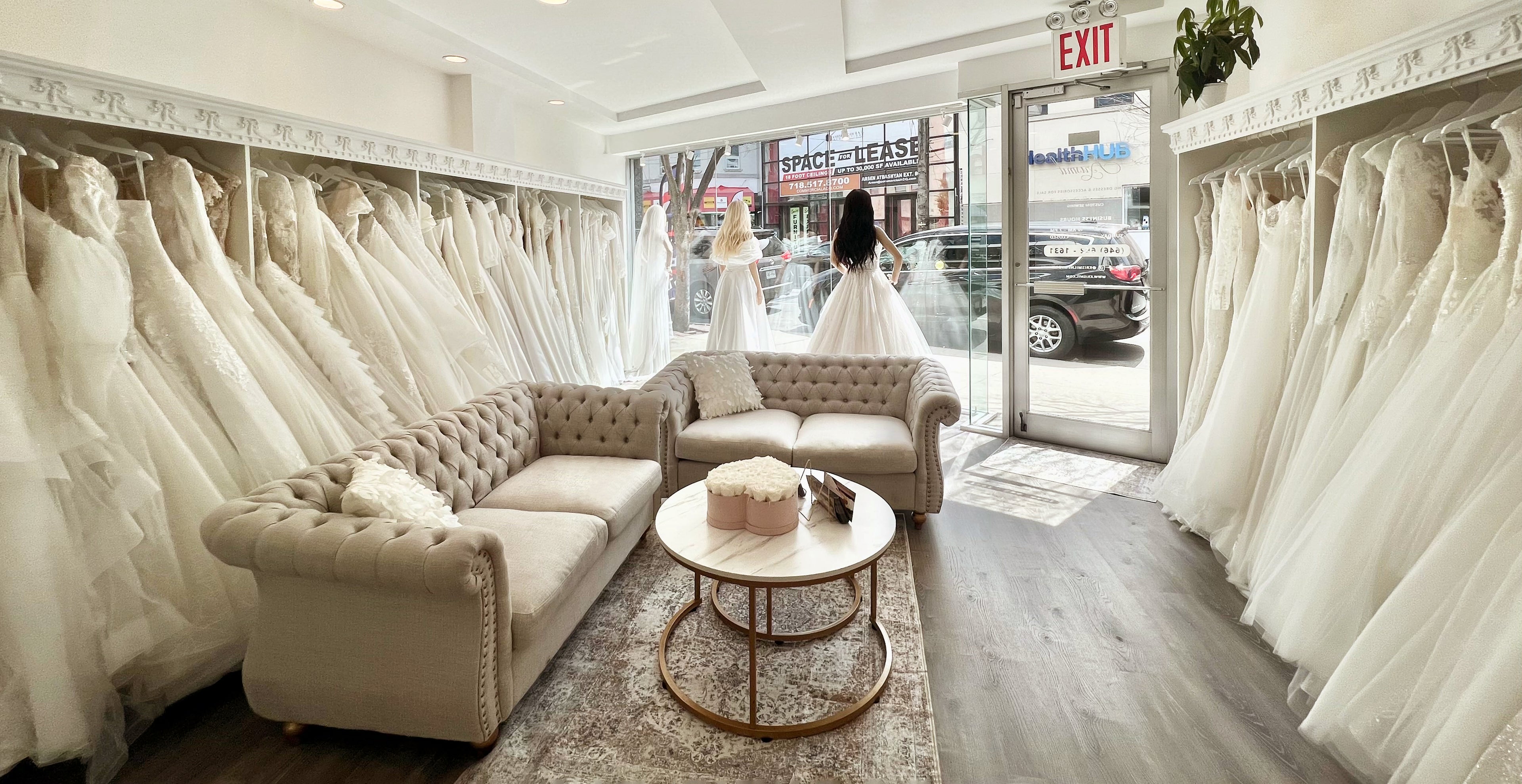 Interior view of Krismil Bridal, a Brooklyn bridal shop with elegant wedding dress racks and a warm, inviting atmosphere.